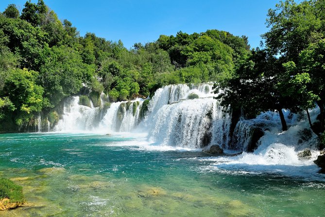 Krka Waterfalls tour with Trogir Walking tour and Krka panoramic boat cruise - Skradinski Buk: travertine cascades and boardwalk rhythm